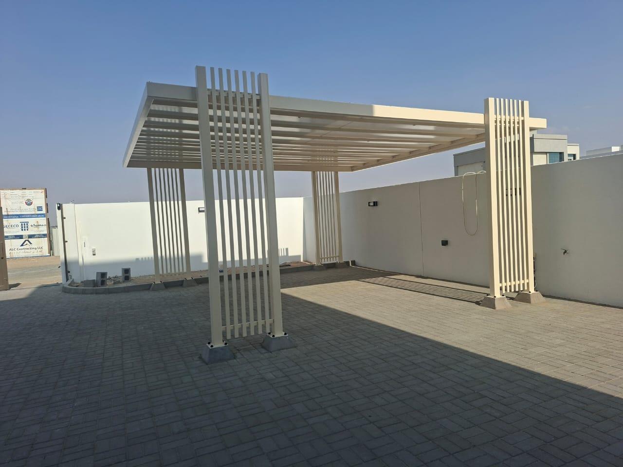 Cream slatted carport with clustered pillars on interlocking pavers